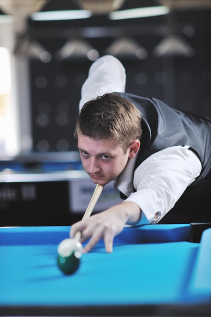 Photo young pro billiard player finding best solution and right angle at billard or snooker pool sport  game