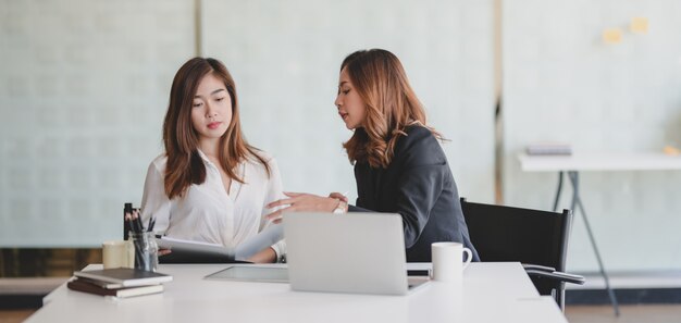 young professional businesswomen discussing on the project together