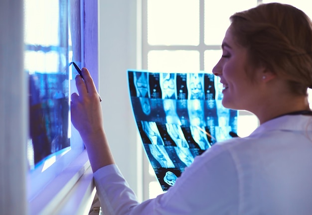 Young professional female doctor examining patients xray