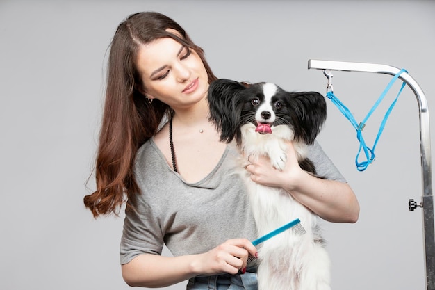 Young professional groomer with pets