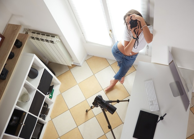 Young professional photographer working in home studio