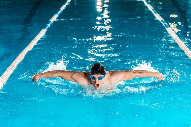 Young professional swimmer in the pool