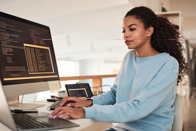 Young programmer checking code she written for project