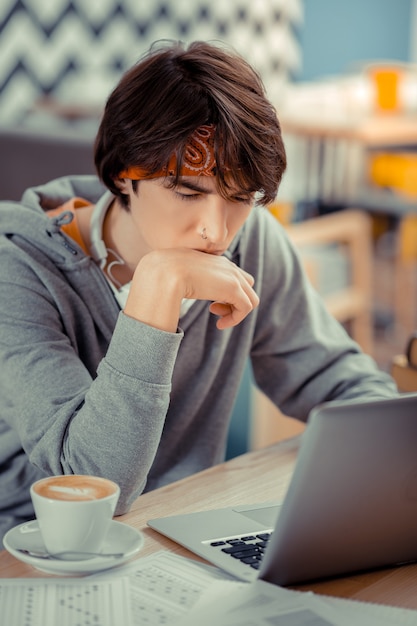 The young programmer. The concentrated student working on creating his own app