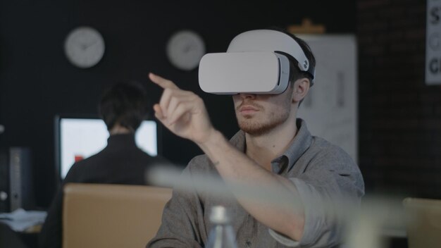 young programmer using vr glasses designer testing 3d game in night office