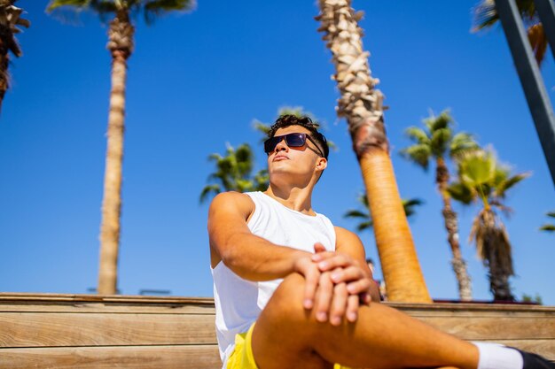 Young proud haughty handsome man enjoying sunny day in beach