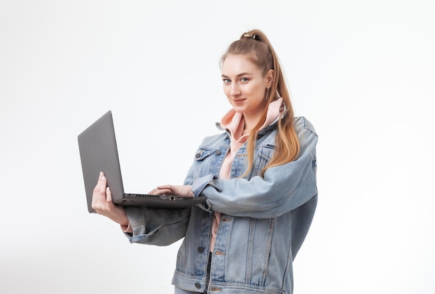 Young purposeful woman student with laptop isolated on white background