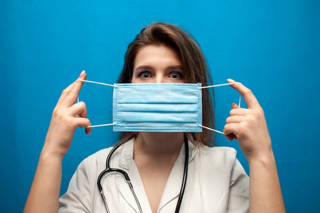 Young putting a medical mask on her face