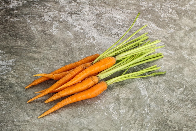 Young raw organic carrot heap isolated