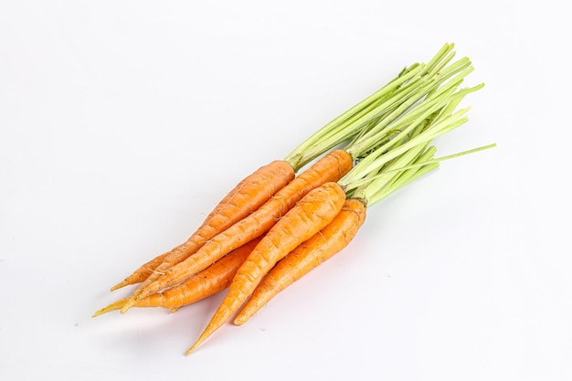 Young raw organic carrot heap isolated