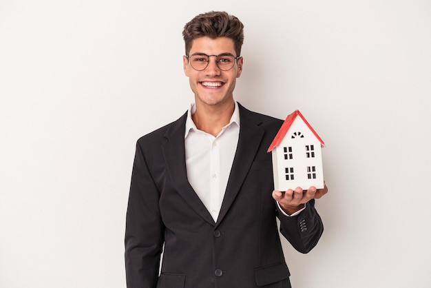 Young real estate caucasian agent isolated on white background happy, smiling and cheerful.