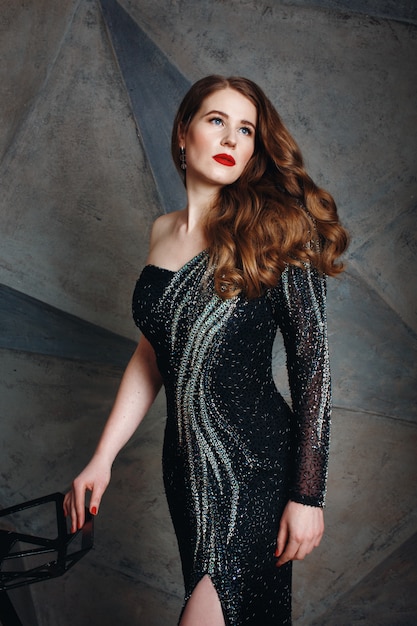 Young Red Hair Woman in Luxury Black Dress