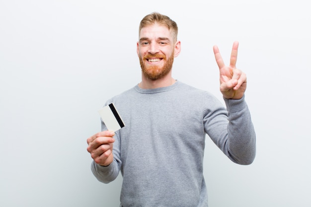 Young red head man   white wall