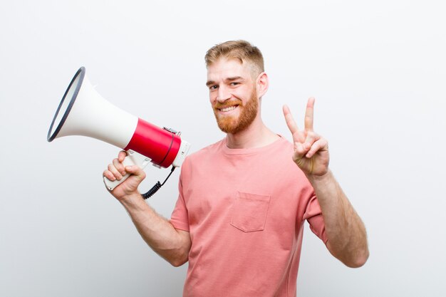 Young red head man with a megaphone