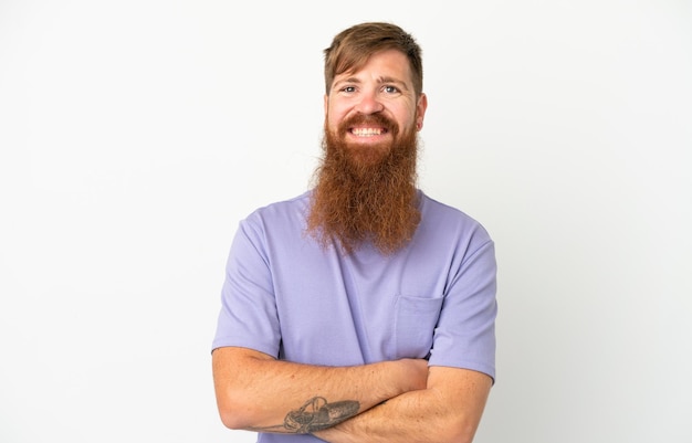 Young reddish caucasian man isolated on white background keeping the arms crossed in frontal position