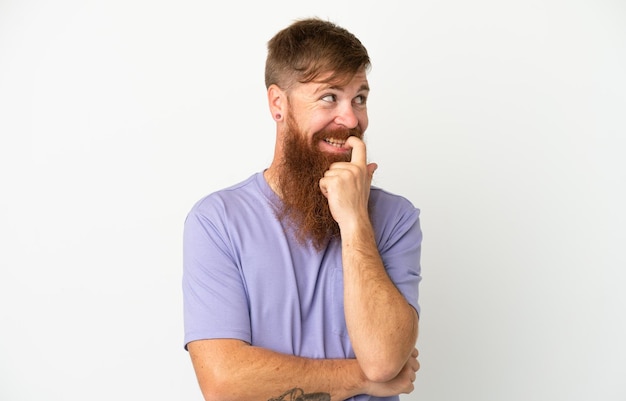 Young reddish caucasian man isolated on white background nervous and scared