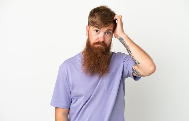 Young reddish caucasian man isolated on white background with an expression of frustration and not understanding