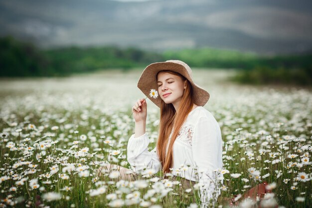 Young redhaired traveler in fairytale beautiful scenery.