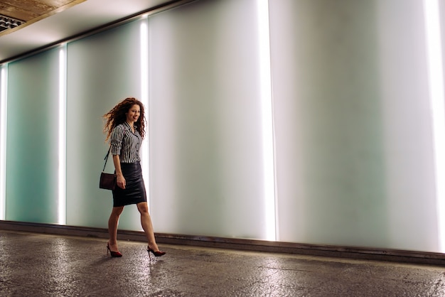 Young redhead business woman walking to work