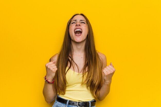 Young redhead ginger woman with freckless cheering carefree and excited.