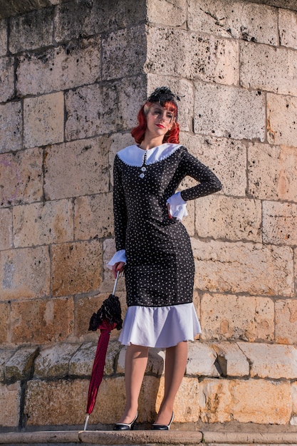 Young redhead girl on a retro vintage dress