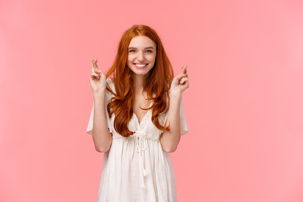 young redhead girl with crossed fingers