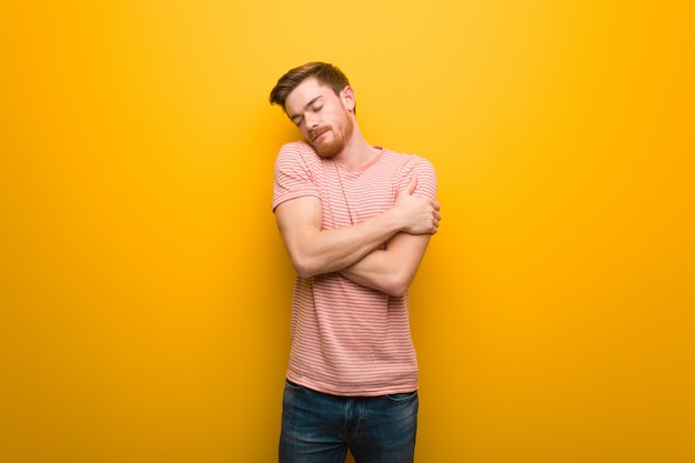 Young redhead man giving a hug