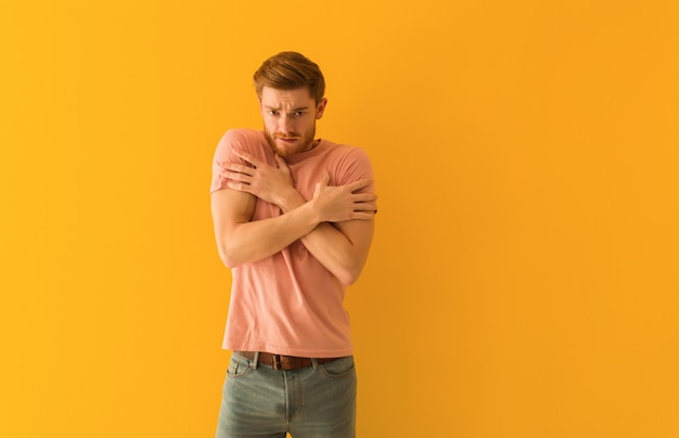 Young redhead man going cold due to low temperature