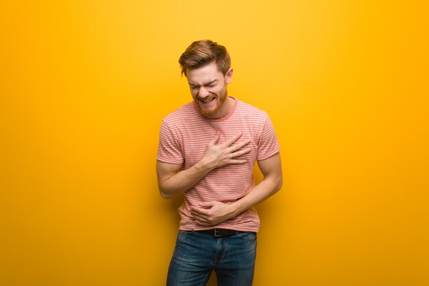 Young redhead man laughing and having fun