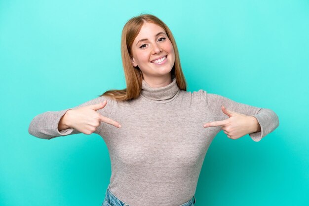 Young redhead woman isolated on blue background proud and selfsatisfied