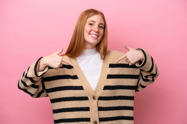 Young redhead woman isolated on pink background proud and selfsatisfied