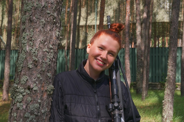 Young redhead woman protecting her house or on tactical gun training classes woman with weapon