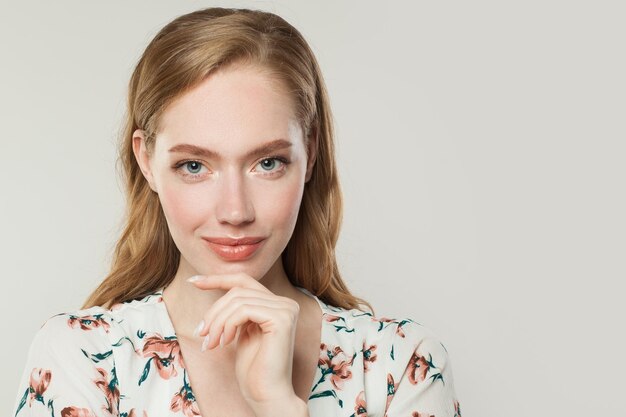 Young redhead woman thinking on white background