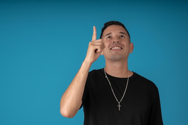 Young religious man pointing to the sky