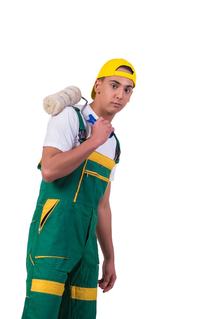 Young repairman painter with roller isolated on white