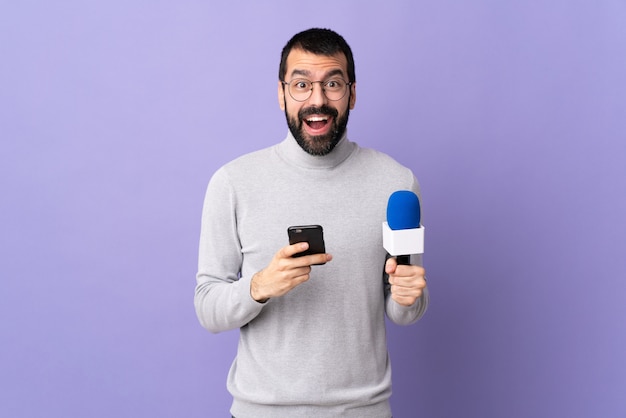 Young reporter man over isolated wall