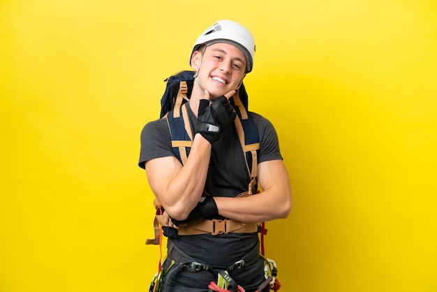 Young rock climber Brazilian man happy and smiling