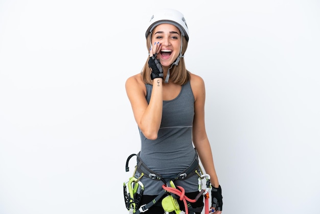 Young rockclimber woman isolated on white background shouting with mouth wide open