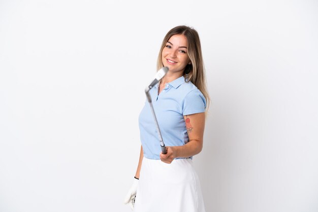 Young Romanian woman isolated on white background playing golf