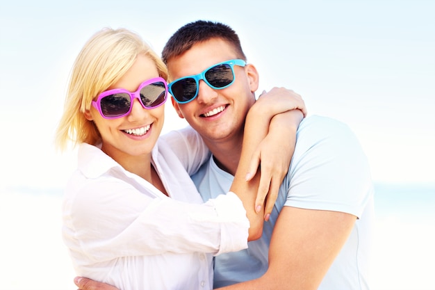 young romantic couple hugging at the beach