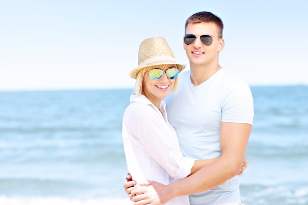 young romantic couple hugging over sea