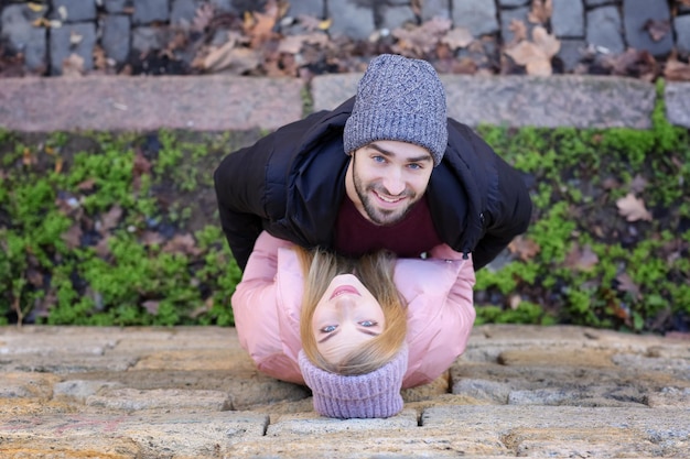 Young romantic couple near stone wall outdoors top view