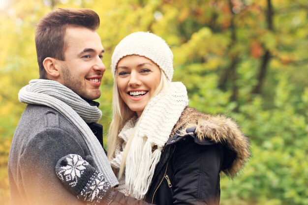 young romantic couple in the park in autumn