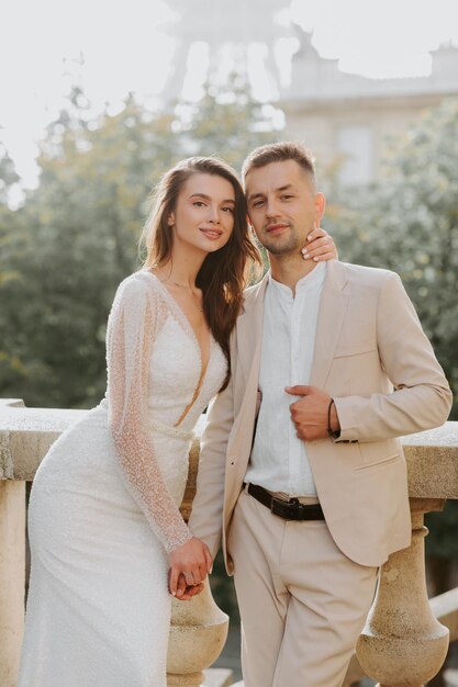 Young romantic couple standing in front of the Eiffel Tower