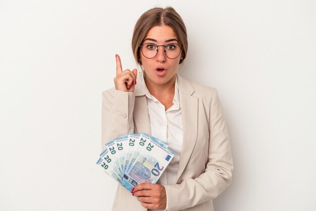 Young Russian business woman holding banknotes isolated on white background having some great idea, concept of creativity.