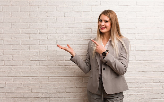 Young russian business woman holding something with hand