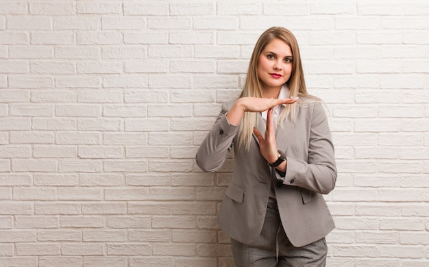 Young russian business woman praying very happy and confident