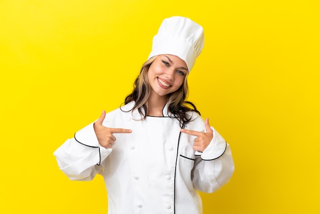 Young Russian chef girl isolated on yellow background proud and self-satisfied