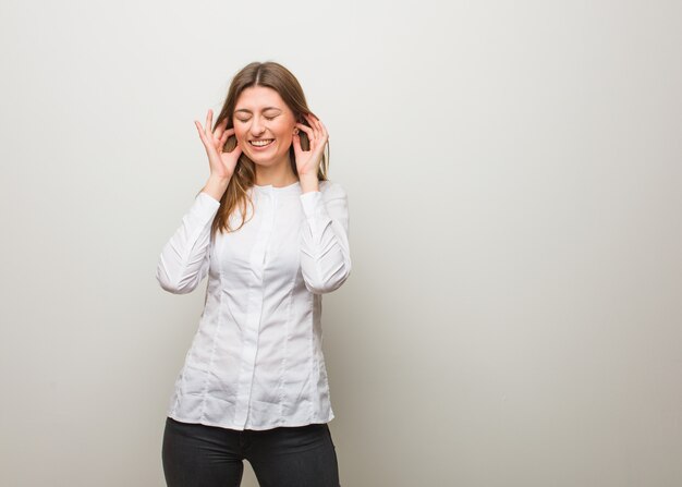 Young russian girl covering ears with hands