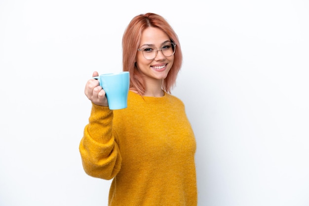 young russian girl holding cup of coffee isolated on white background with happy expression